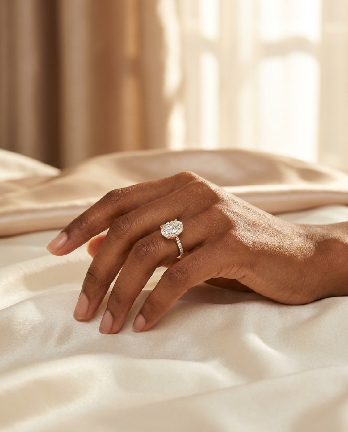 Custom gold solitaire engagement ring on a client's hand